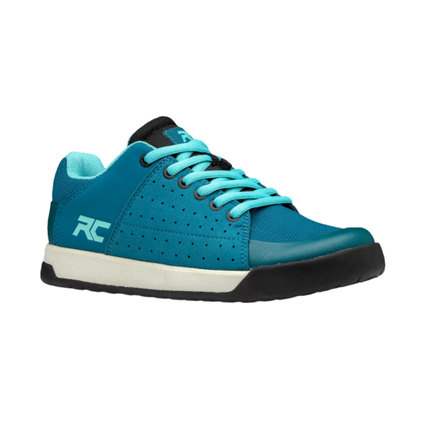 A blue and white women's flat pedal shoe with black accents and a rubber outsole, featuring the RC logo.