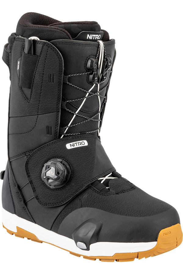 Black snowboard boot with orange sole on a white background