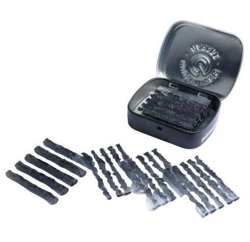 Set of black wax strips with a metal tin on a white background